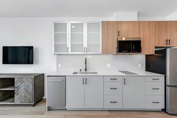 Kitchens include: microwave, stovetop, garbage disposal, and refrigerator